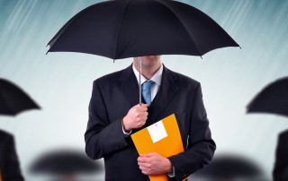 Businessman with umbrellas in heavy rain.