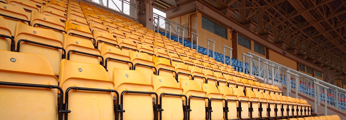 Plenty of yellow plastic seats at stadium