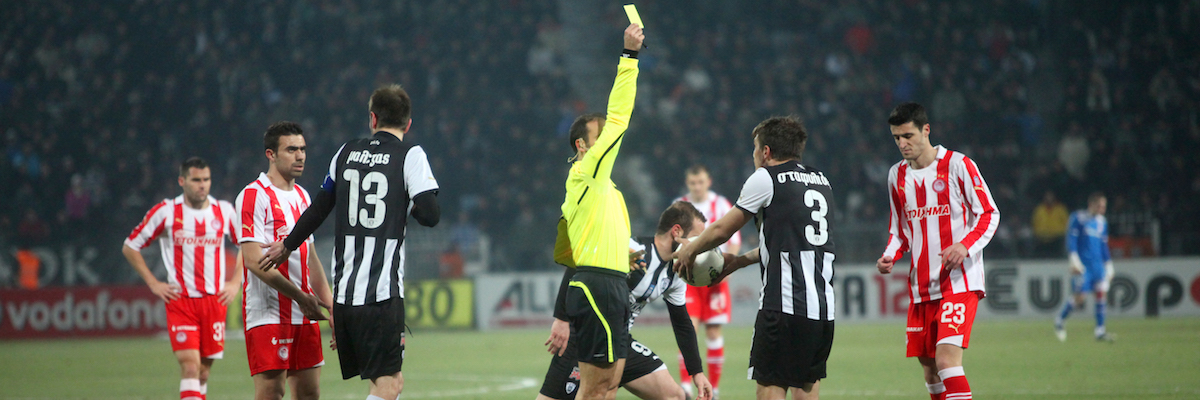 THESSALONIKI, GREECE - FEBRUARY 5: Kostas Stafilidis received a yellow card by the referee Thanasis Giahos in football match between Paok and Olympiakos